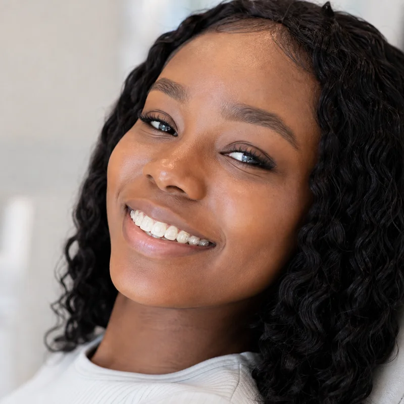 Patient smiling comfortably with clear aligner